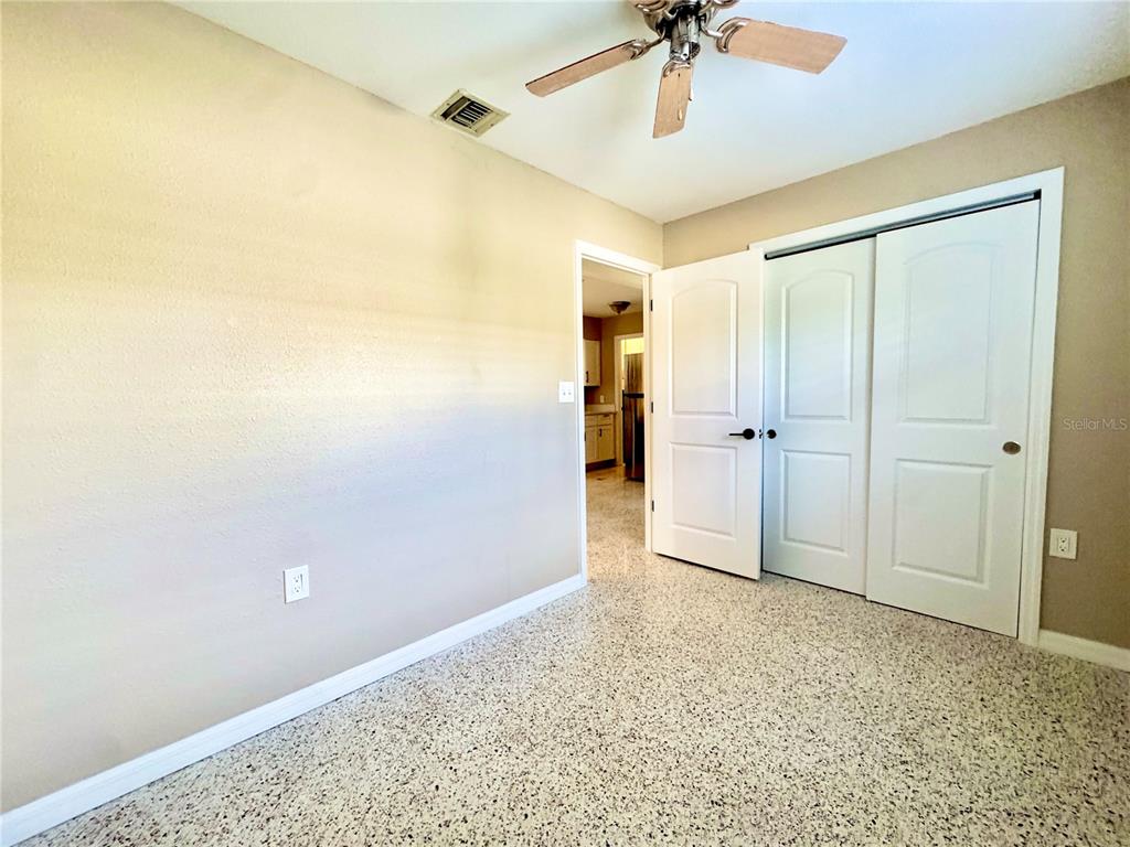 4335 Floramar Terrace New Port Richey, FL 34652 - Photo 13 of 30 a view of empty room with a ceiling fan