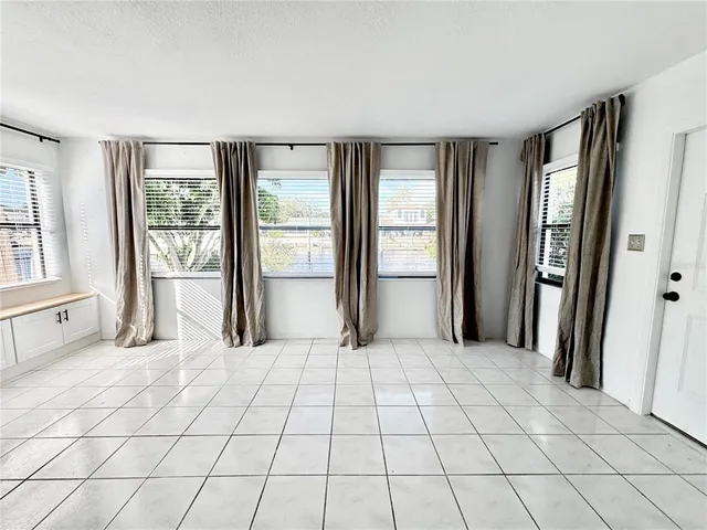 a large room with a large window and doors