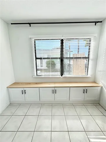 a view of a kitchen with white cabinets