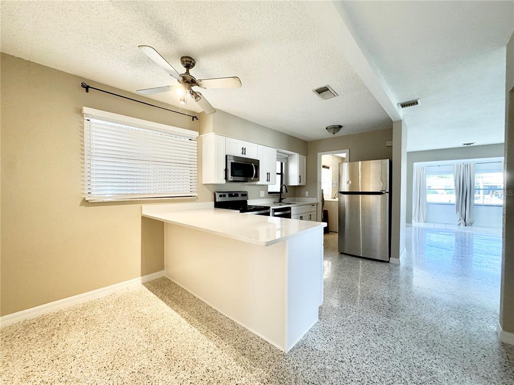4335 Floramar Terrace New Port Richey, FL 34652 - Photo 5 of 30 a kitchen with refrigerator and window