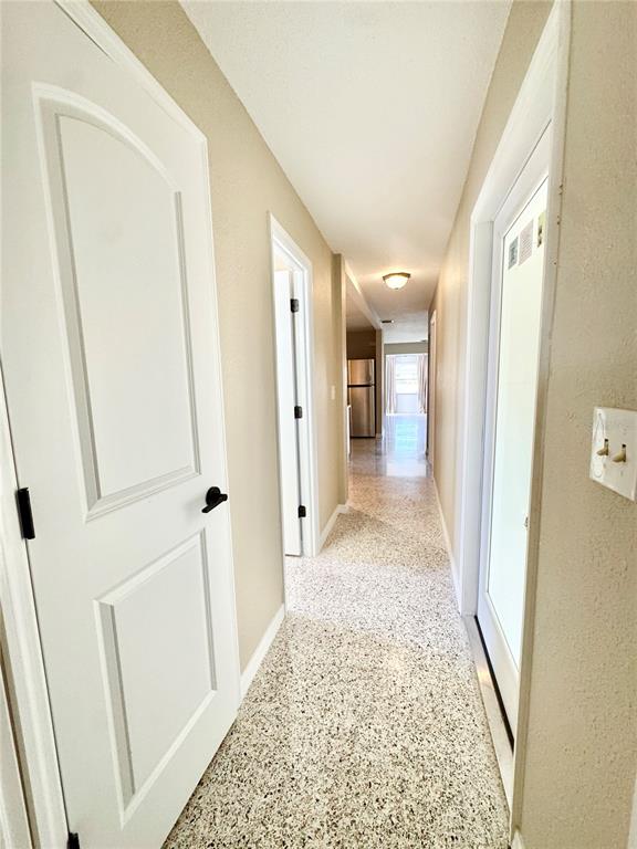 4335 Floramar Terrace New Port Richey, FL 34652 - Photo 10 of 30 a view of a hallway with wooden floor and staircase