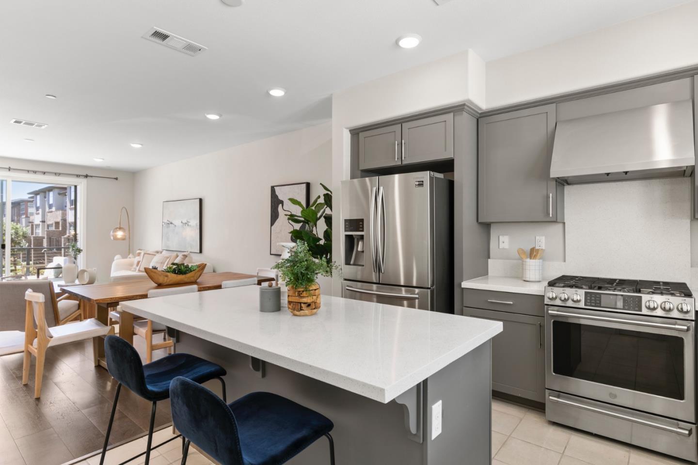 875 Cotati Terrace, Unit 3 Sunnyvale, CA 94085 - Photo 12 of 36 a kitchen with stainless steel appliances a dining table chairs refrigerator and stove