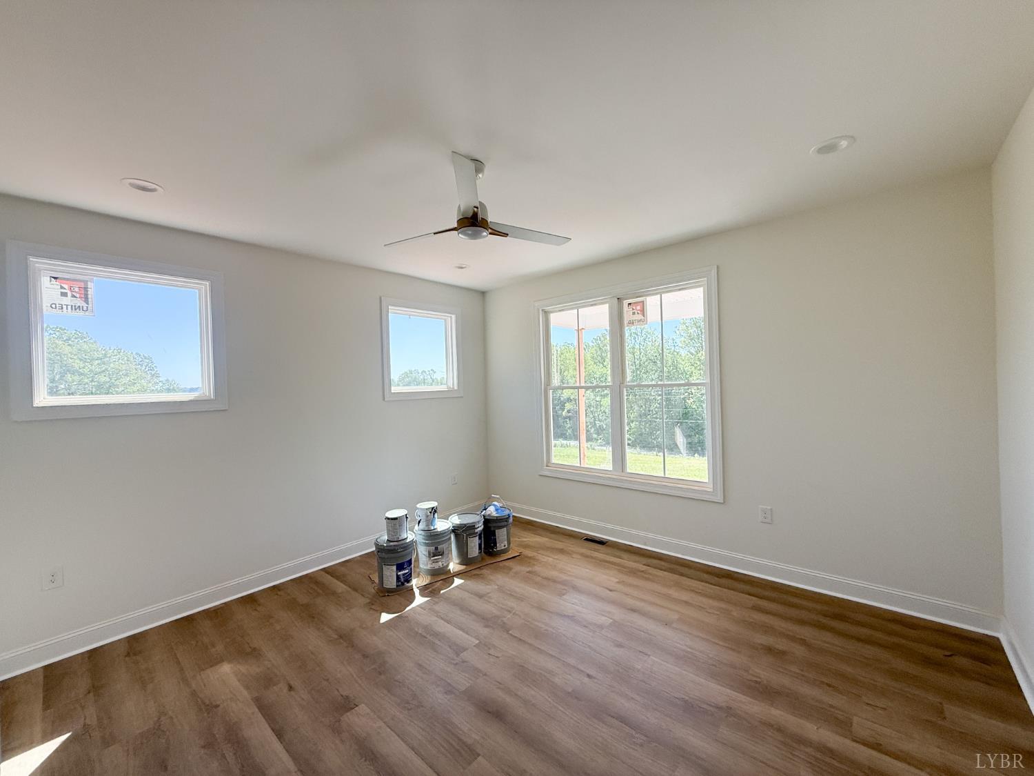 9009 Stonewall Road Appomattox, VA 24522 - Photo 19 of 38 a view of an empty room with wooden floor and a window