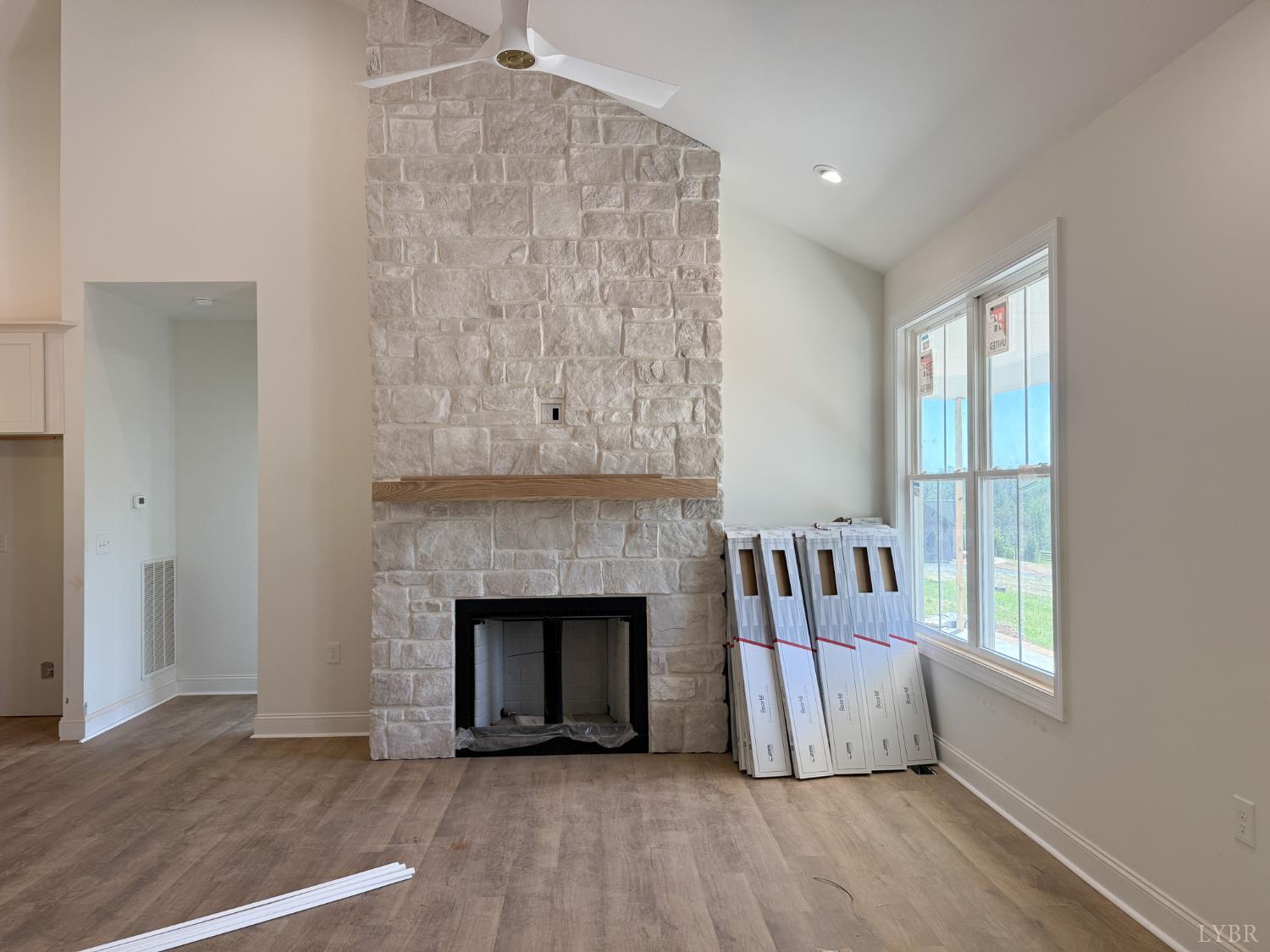 9009 Stonewall Road Appomattox, VA 24522 - Photo 8 of 38 a view of an empty room with wooden floor and a window