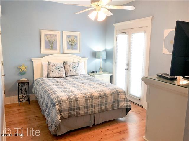 21605 Front Beach Road Panama City Beach, FL 32413 - Photo 9 of 17 a bedroom with a bed and a flat tv screen on a dresser