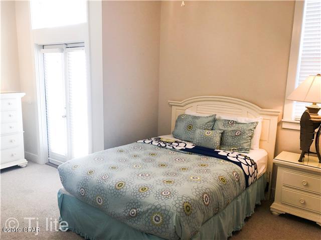 21605 Front Beach Road Panama City Beach, FL 32413 - Photo 10 of 17 a bedroom with a bed and a window