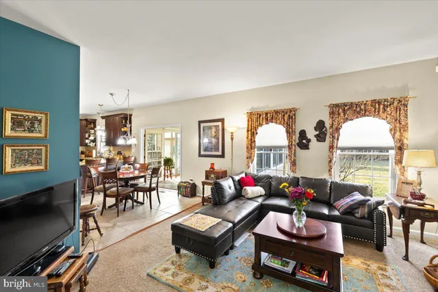 a view of a livingroom with furniture wooden floor and windows