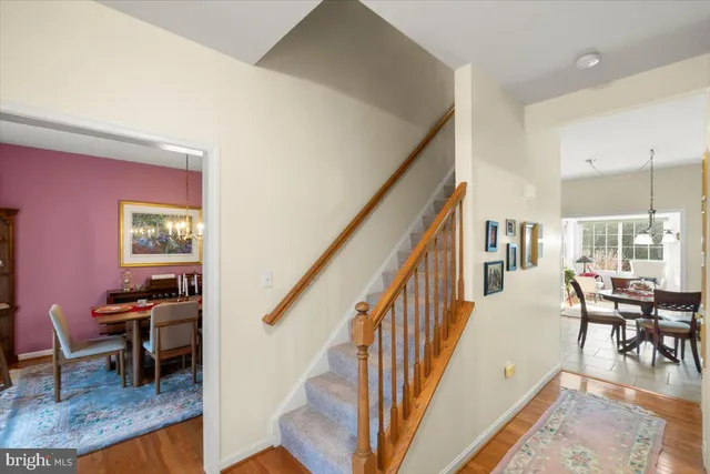 a kitchen with stainless steel appliances granite countertop a stove a refrigerator a kitchen island a sink a dining table and chairs