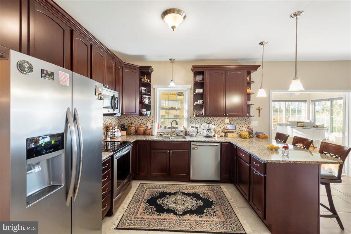 334 Friendship Lane Gettysburg, PA 17325 - Photo 23 of 64 a kitchen with stainless steel appliances granite countertop a sink stove and refrigerator