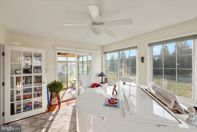 a view of a hallway to a livingroom with furniture and a window
