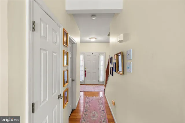 a view of a hallway with workspace and a window