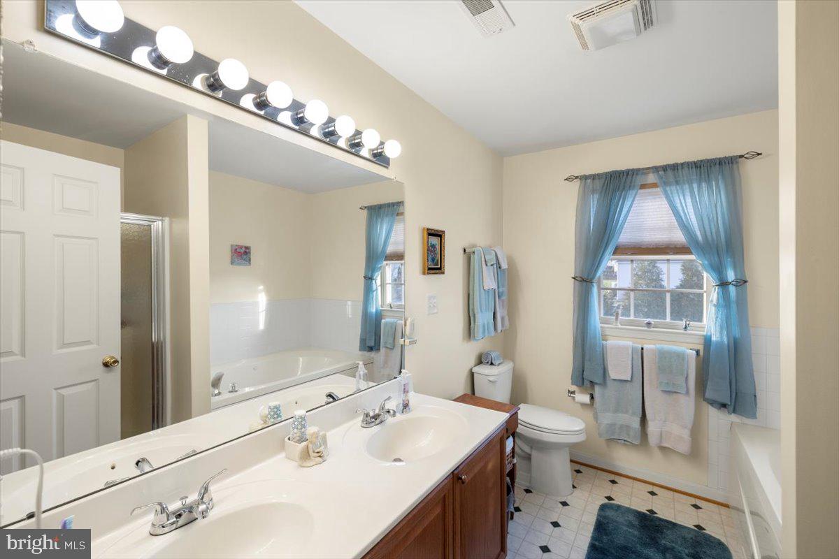 334 Friendship Lane Gettysburg, PA 17325 - Photo 46 of 64 a spacious bathroom with a double vanity sink mirror and toilet