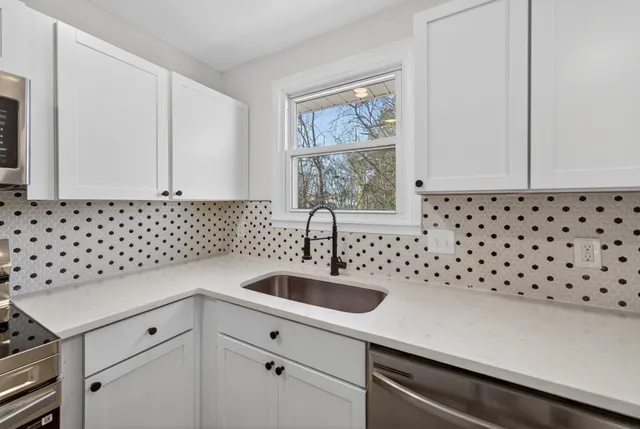 a kitchen with a sink and cabinets