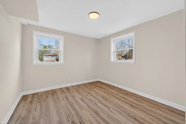 a view of room with window and wooden floor