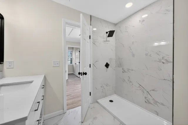 a bathroom with a shower and a sink