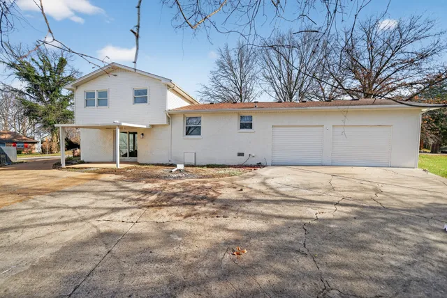 a view of garage yard and tree