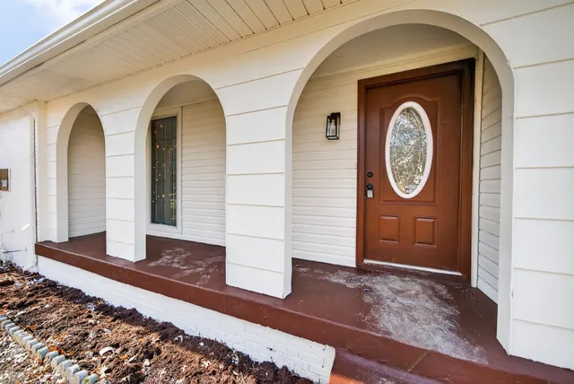 a front view of a house with garden