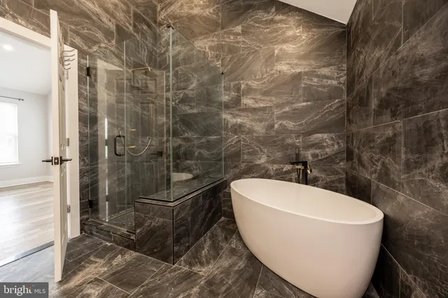a white bath tub sitting in a bathroom
