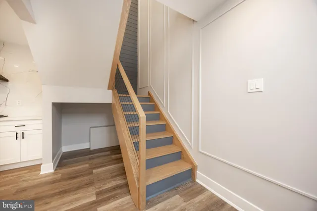 a view of entryway and hall with wooden floor