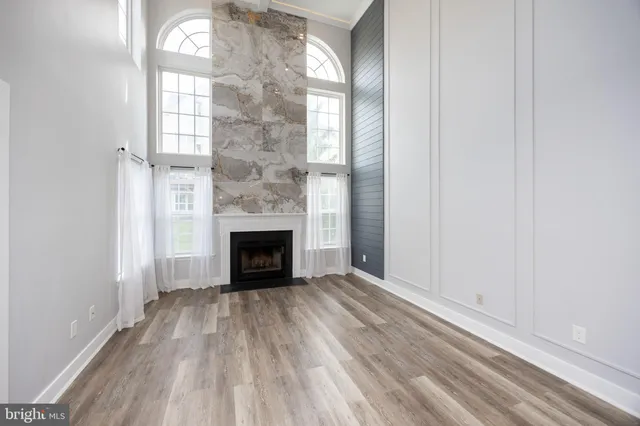 a view of a livingroom with a fireplace and window