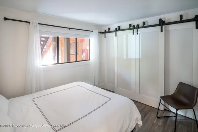 a bedroom with a bed and a chair