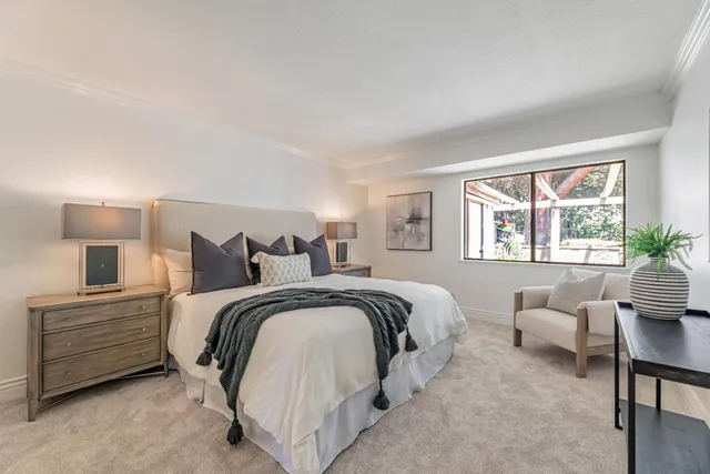 a spacious bedroom with a bed and a couch