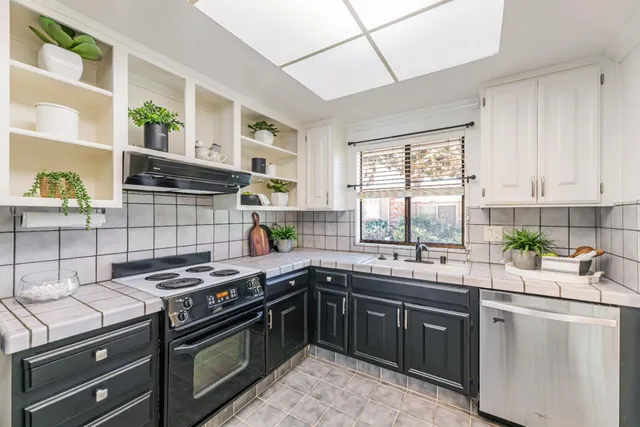 a kitchen with a sink stove and cabinets