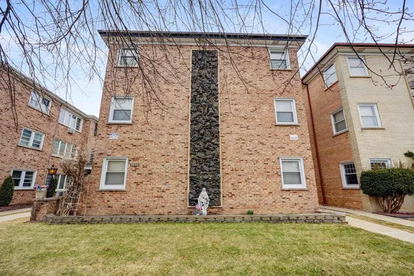 a brick building with a yard in front of it