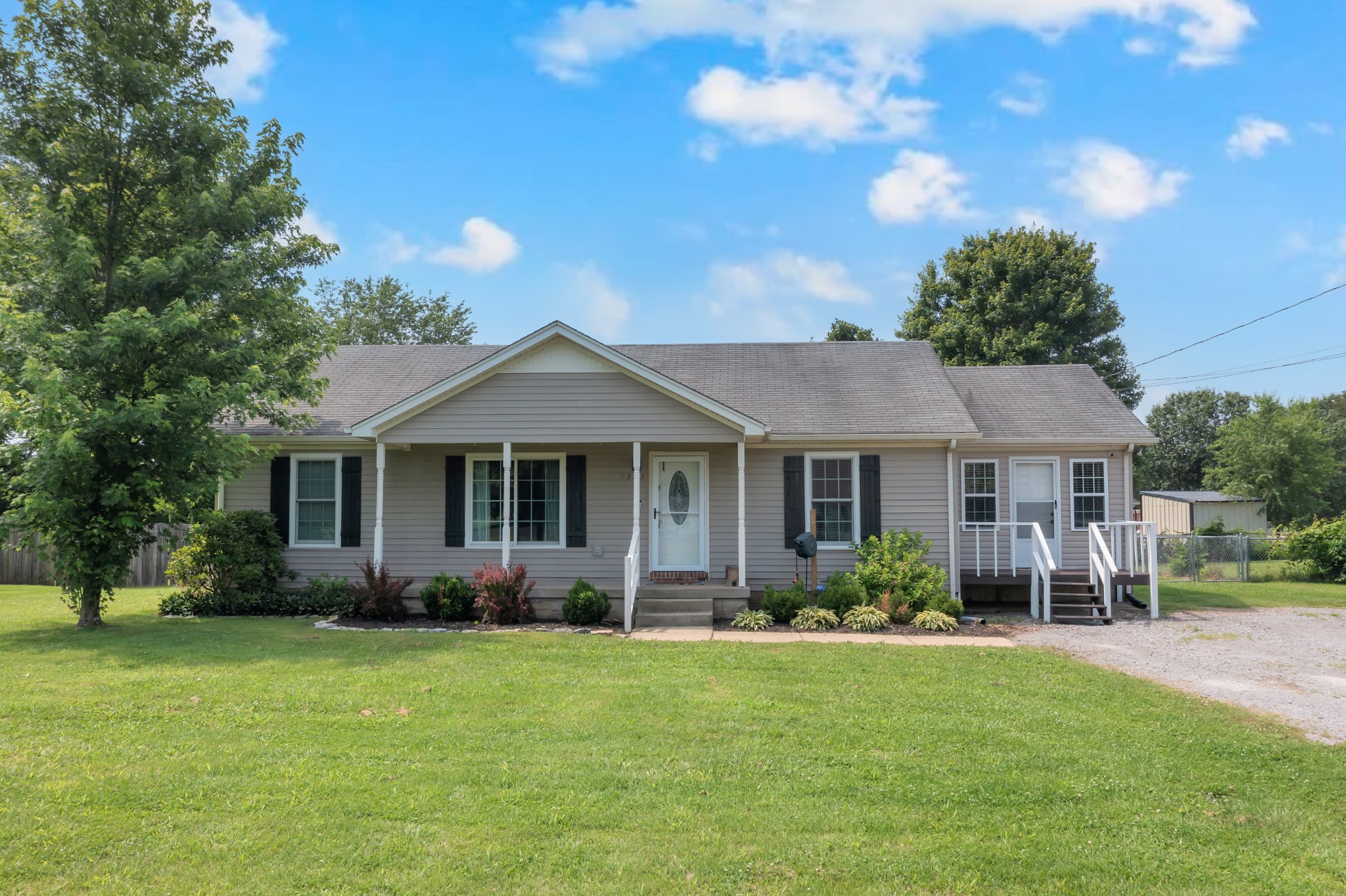 a front view of house with yard and green space
