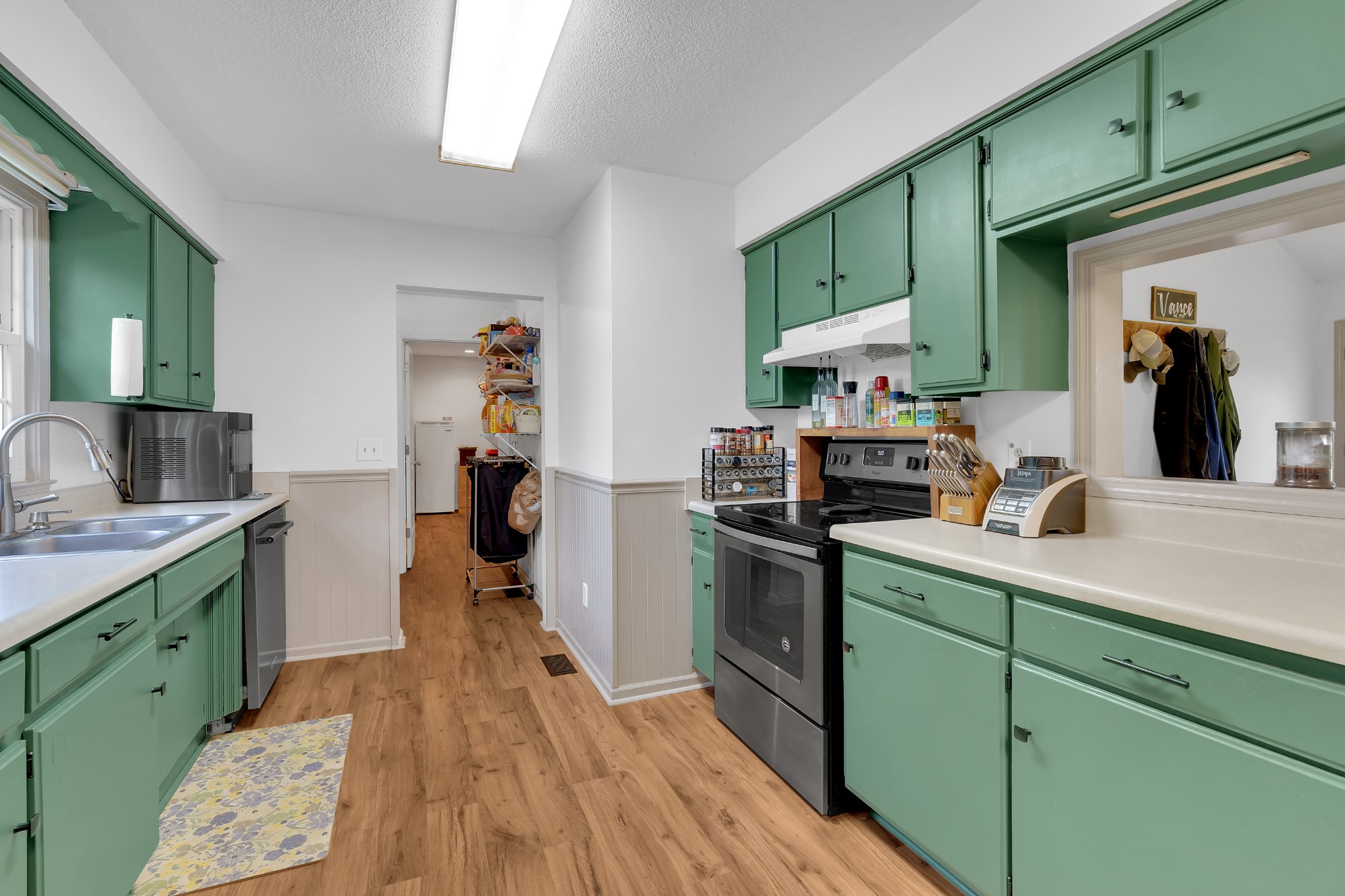 5363 Candy Cane Court Murfreesboro, TN 37129 - Photo 13 of 34 a kitchen with stainless steel appliances granite countertop a sink dishwasher stove and cabinets with wooden floor