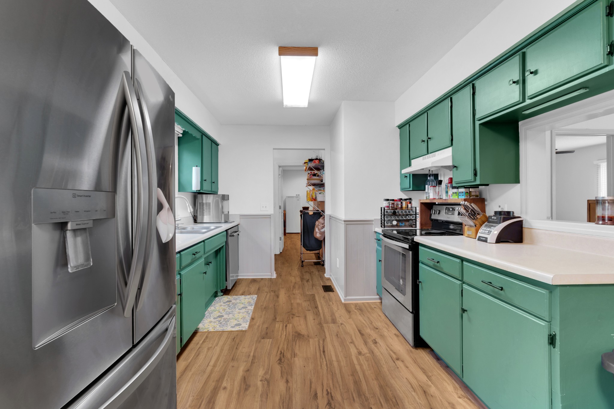 5363 Candy Cane Court Murfreesboro, TN 37129 - Photo 14 of 34 a kitchen that has a lot of cabinets a sink and wooden floor