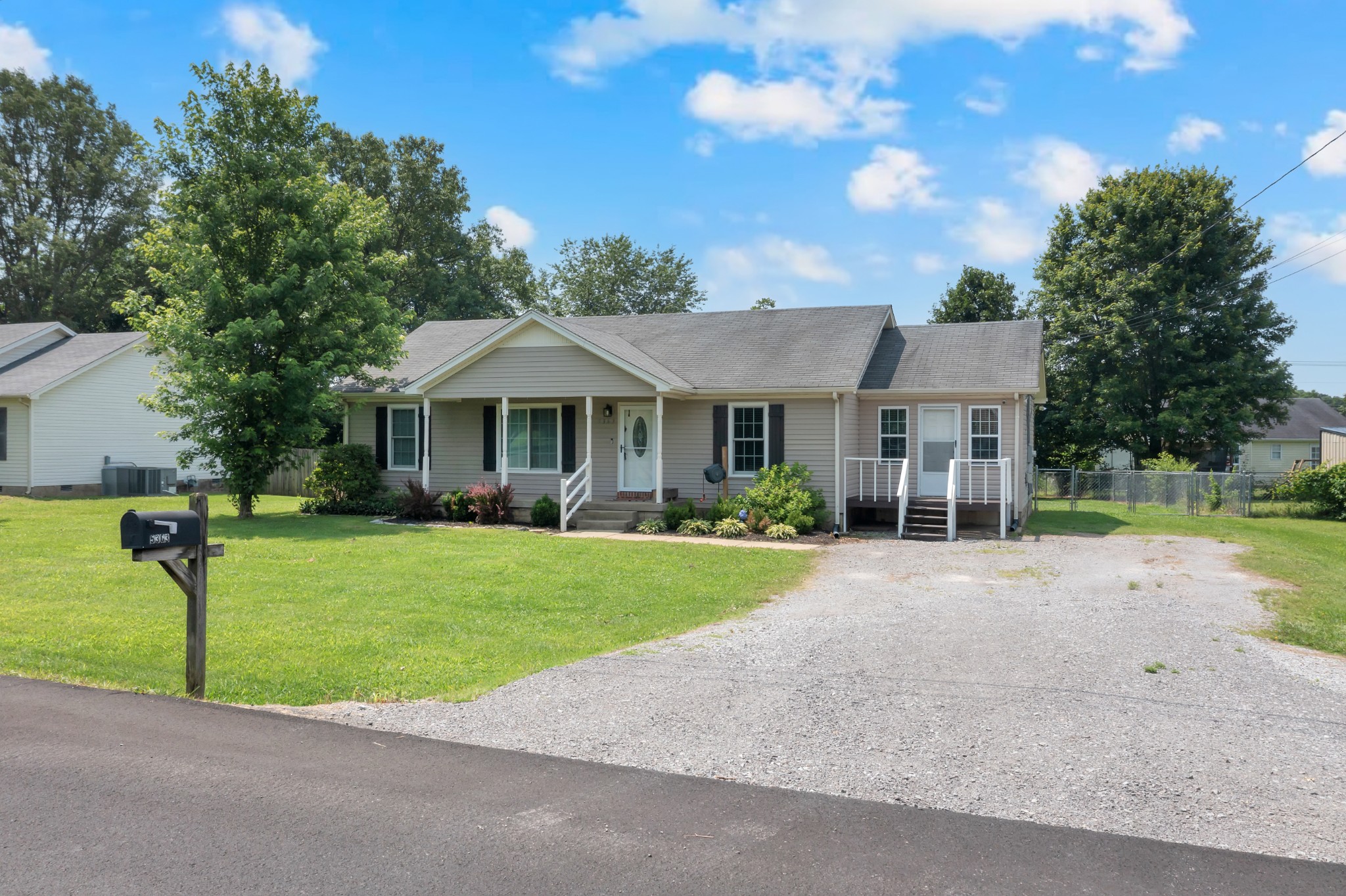 5363 Candy Cane Court Murfreesboro, TN 37129 - Photo 32 of 34 a front view of a house with a garden and porch
