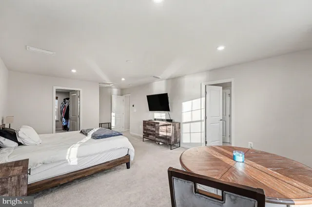 a bedroom with a bed and large windows