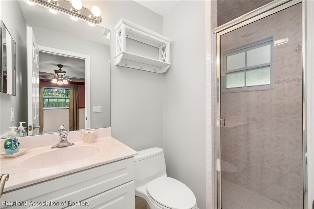 1630 Sentinel Road Sebring, FL 33875 - Photo 18 of 48 Full bathroom in 2nd bedroom with cultured marble vanity and walk-in tile shower