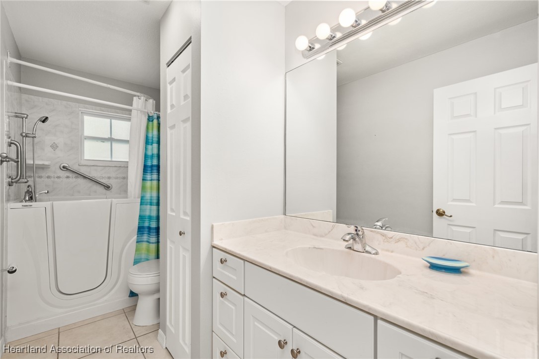 1630 Sentinel Road Sebring, FL 33875 - Photo 20 of 48 3rd bathroom has a wide cultured marble vanity, linen closet and handicap tub/shower