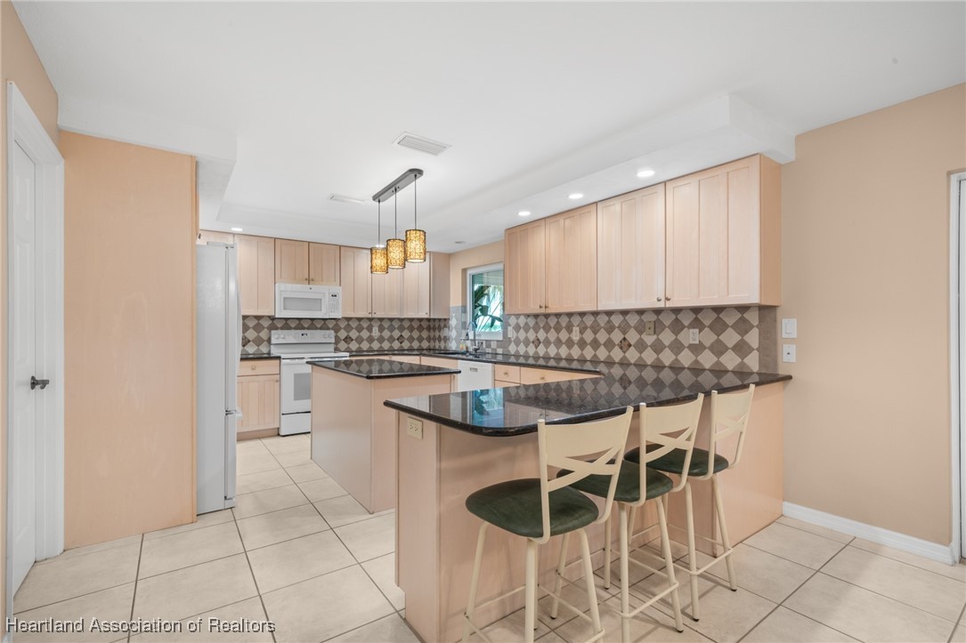 1630 Sentinel Road Sebring, FL 33875 - Photo 5 of 48 So much prep space in the beautiful kitchen