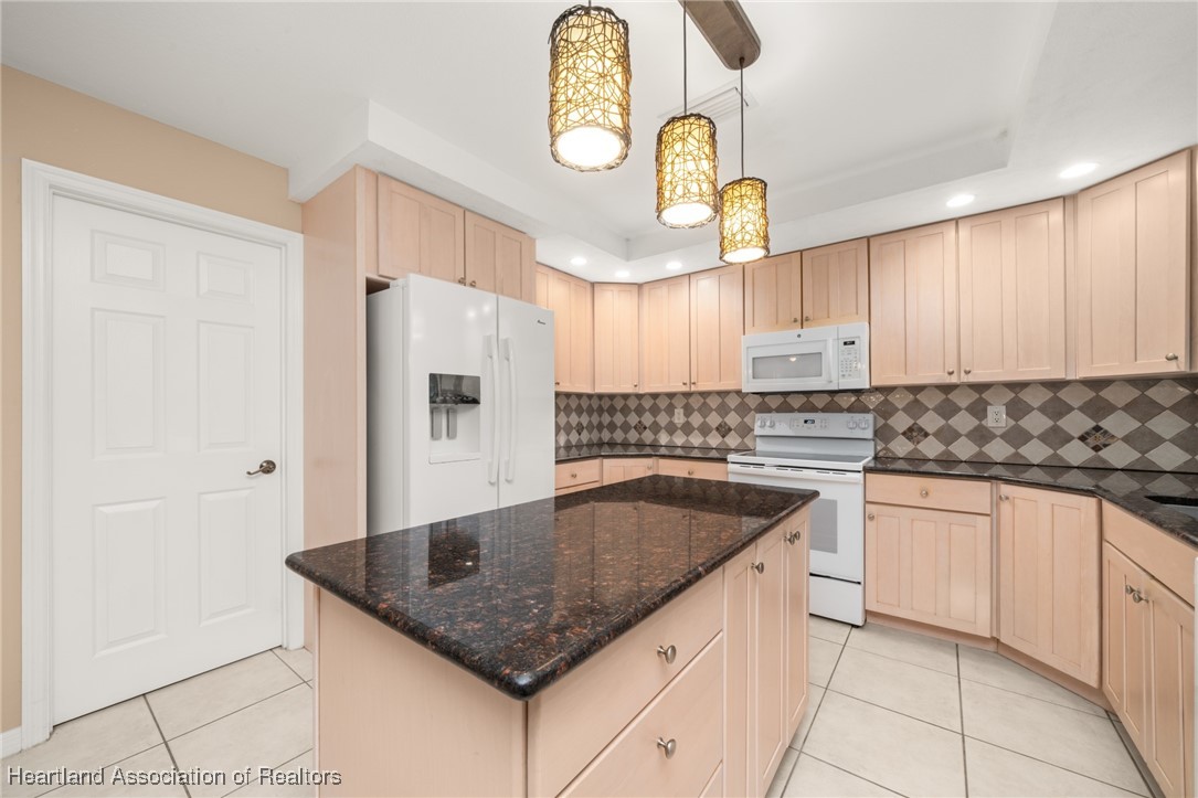 1630 Sentinel Road Sebring, FL 33875 - Photo 6 of 48 Kitchen highlighted by granite countertops, center island and pendant lighting