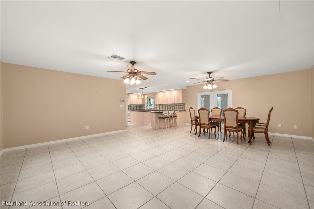 1630 Sentinel Road Sebring, FL 33875 - Photo 10 of 48 Dining room has French doors to expansive porch