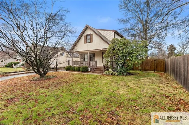 a view of a house with a yard covered in snow