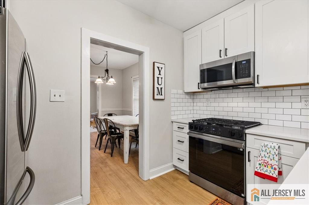 21 Heathcote Brook Road Kingston, NJ 08528 - Photo 11 of 24 a kitchen with stainless steel appliances a stove microwave and a refrigerator