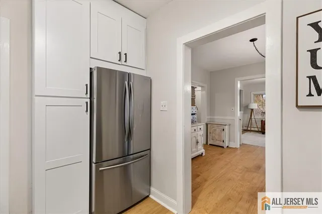 a kitchen with stainless steel appliances a refrigerator and cabinets