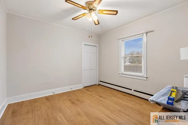 a view of a room with wooden floor and fan