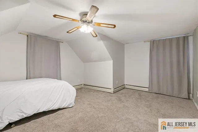 a bedroom with a bed and a ceiling fan