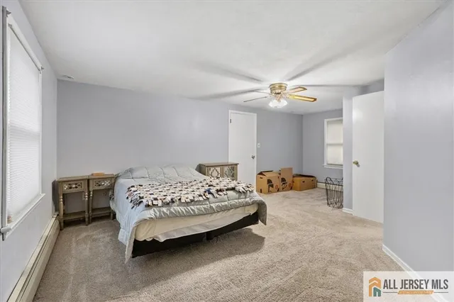 a bedroom with a bed and ceiling fan