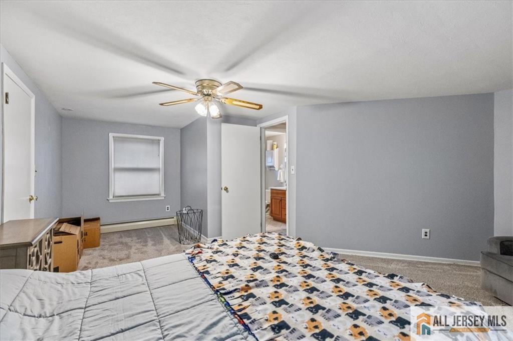 21 Heathcote Brook Road Kingston, NJ 08528 - Photo 19 of 24 a bedroom with a bed and a chandelier