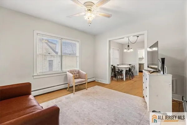 a living room with furniture and a chandelier