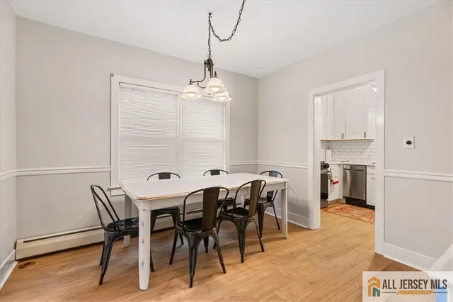 a view of a dining room with furniture and a chandelier
