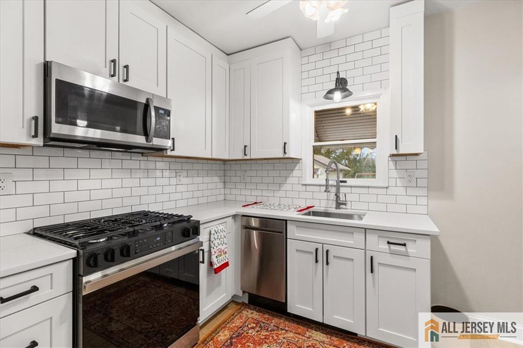 21 Heathcote Brook Road Kingston, NJ 08528 - Photo 10 of 24 a kitchen with stainless steel appliances granite countertop a sink stove and microwave