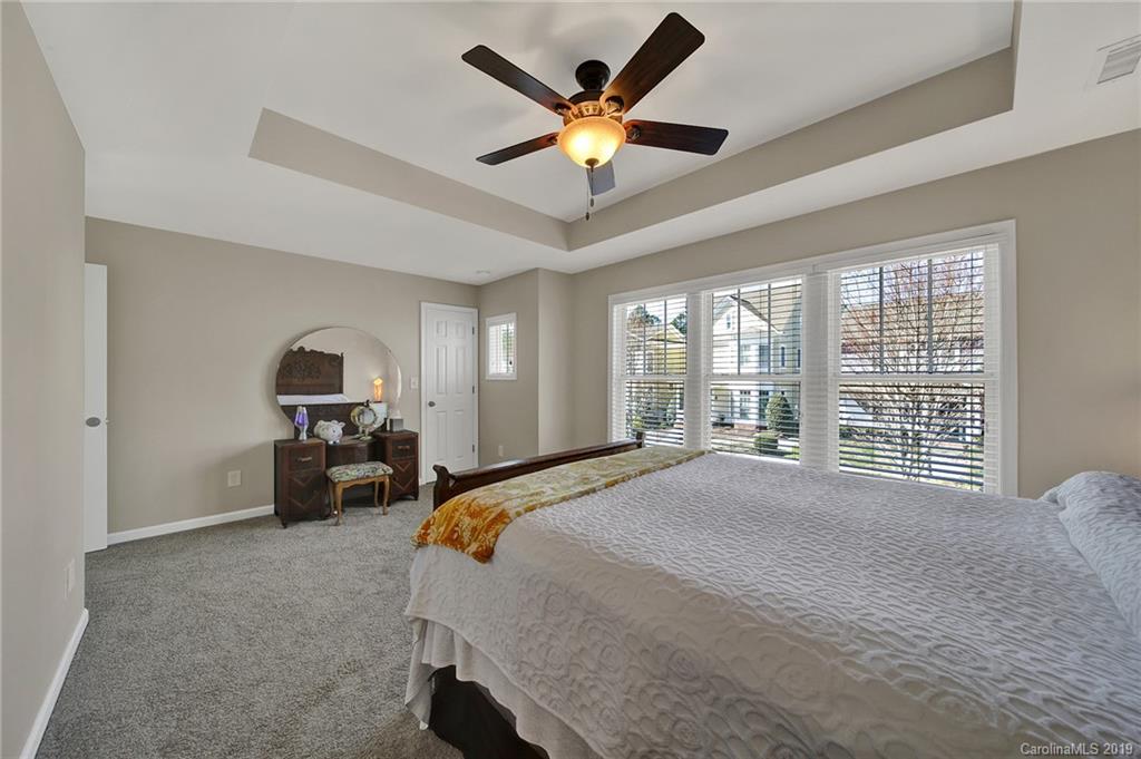 3550 Richard's Crossing Fort Mill, SC 29708 - Photo 21 of 33 a bedroom with a bed a large window and a chandelier