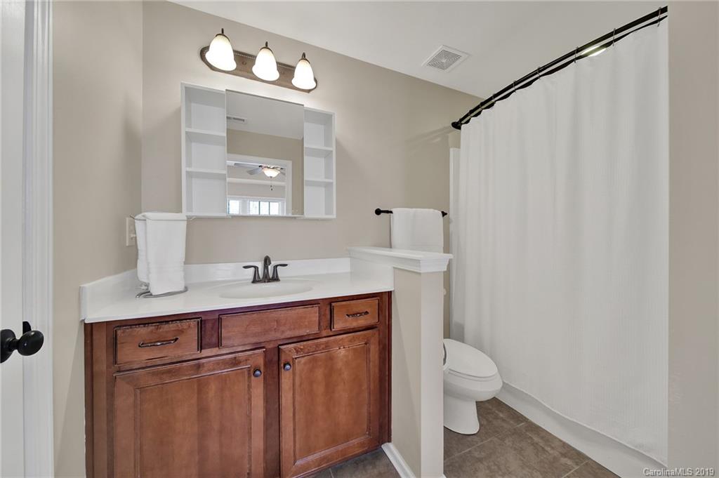 3550 Richard's Crossing Fort Mill, SC 29708 - Photo 22 of 33 a bathroom with a granite countertop sink a toilet and a mirror